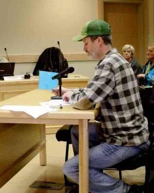 Neighbour Brett Lord used his own building permit to emphasize his opposition to the proposed zoning change.